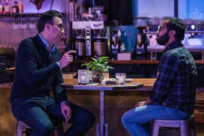 two people chatting over cocktails